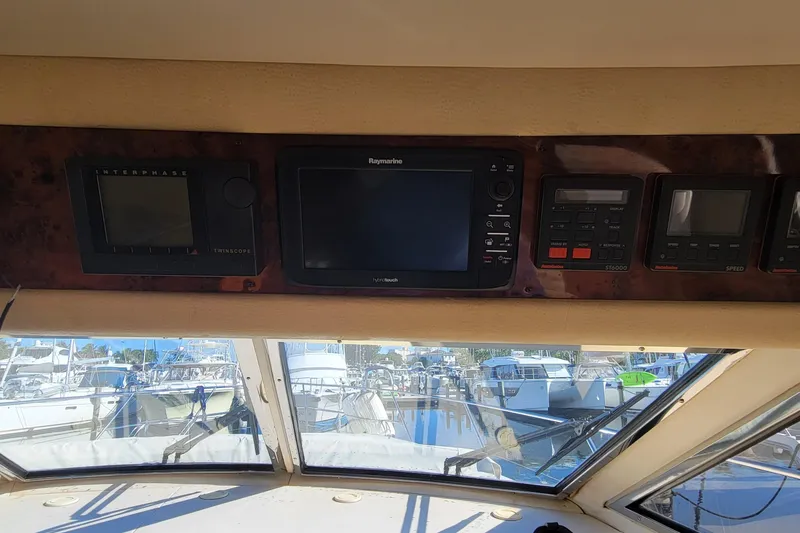 Slide: The Image of Control panel of a 1998 Viking Princess 50 Sport Cruiser with navigation equipment. - 49