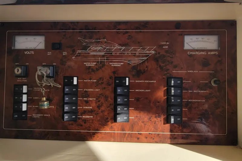 Slide: The Image of 1998 Viking Princess 50 Sport Cruiser control panel with switches and gauges. - 51