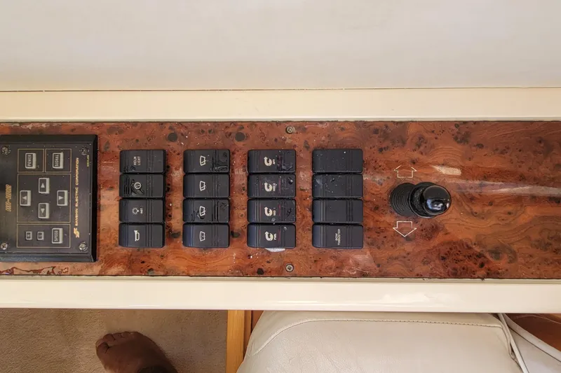 Slide: The Image of Control panel of a 1998 Viking Princess 50 Sport Cruiser with switches and joystick. - 52