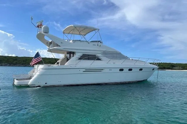 Slide: The Image of View from 1998 Viking Princess 50 Sport Cruiser on calm waterway, city skyline in distance. - 56