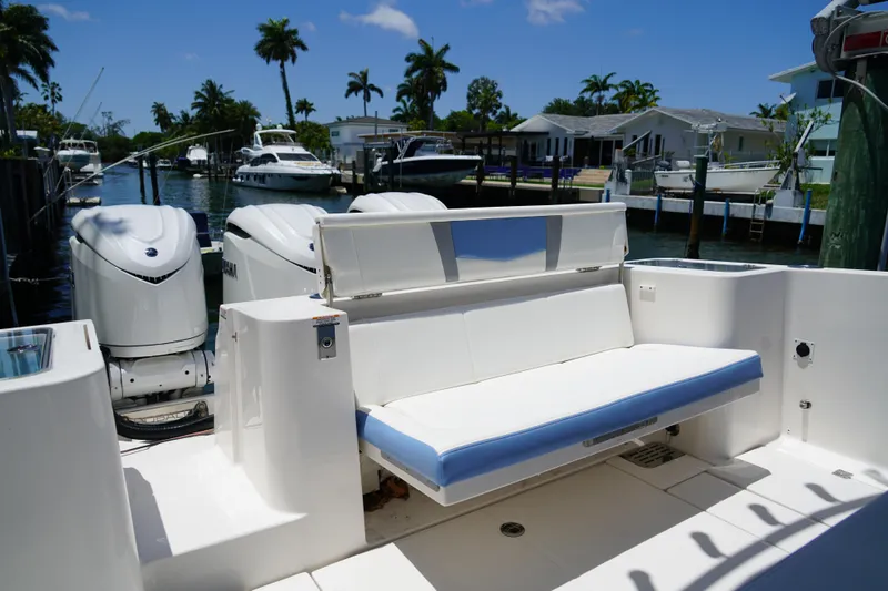 Slide: The Image of 2024 Robalo R360 Center Console boat with white seating and dual outboard engines. - 16