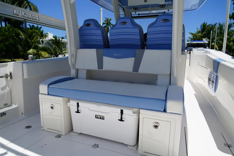 Slide: The Image of 2024 Robalo R360 Center Console boat interior with blue seating and Yeti cooler. - 17