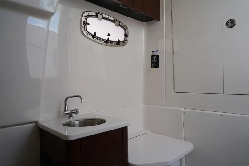 Slide: The Image of 2024 Robalo R360 Center Console interior with sink and porthole window. - 22