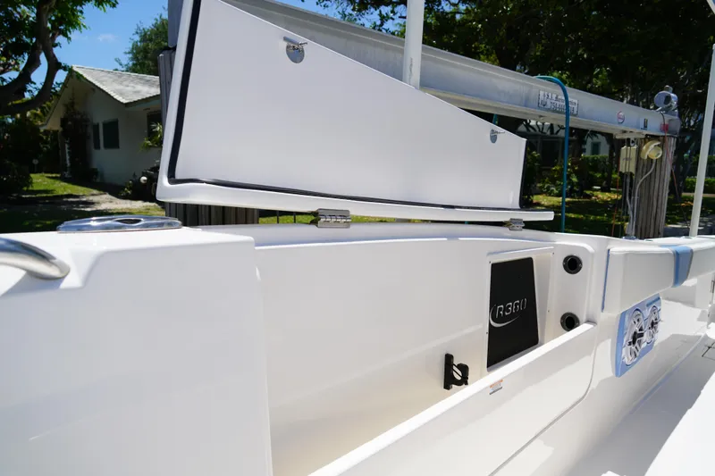 Slide: The Image of 2024 Robalo R360 Center Console boat with open storage compartment and sleek design. - 9