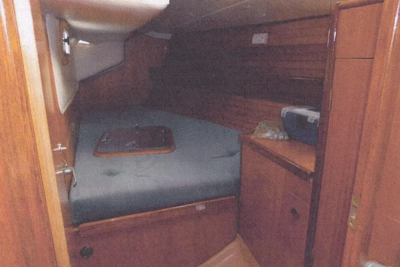 Slide: The Image of Interior cabin of 1983 Beneteau First 38.5 sailboat with wooden finish and cozy bed. - 2
