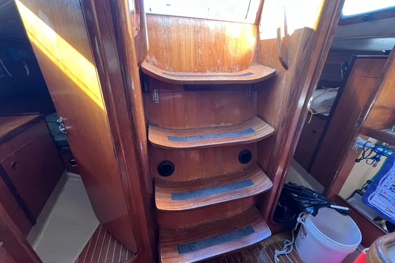 Slide: The Image of Interior of 1983 Beneteau First 38.5 sailboat with wooden steps and cabin view. - 5