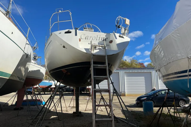 Slide: The Image of 1983 Beneteau First 38.5 sailboat on stands, clear blue sky background. - 7