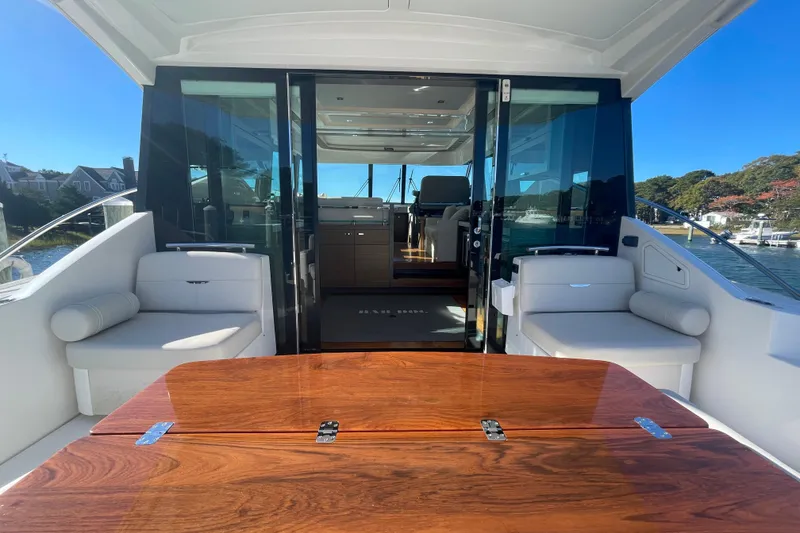 Slide: The Image of Luxurious 2020 Tiara 53C yacht interior with elegant seating and wooden table. - 10