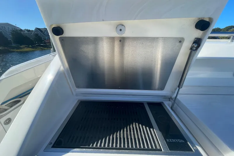 Slide: The Image of Outdoor grill on a 2020 Tiara 53C yacht, featuring a Kenyon cooking surface. - 12