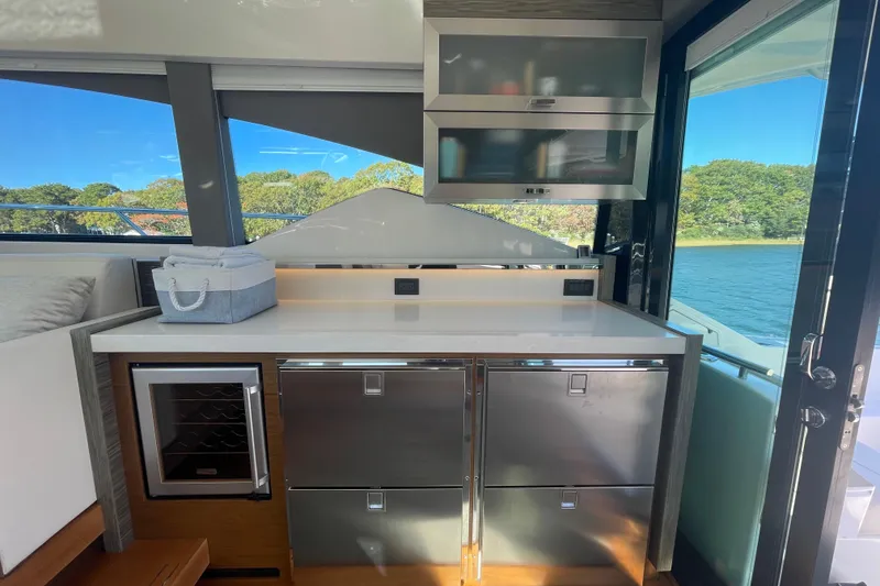 Slide: The Image of Modern kitchen area on a 2020 Tiara 53C yacht with stainless steel appliances. - 14