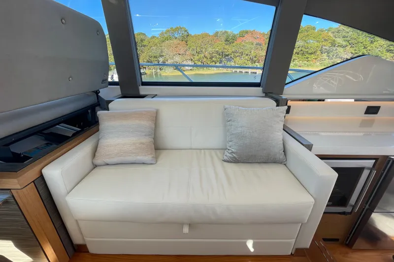 Slide: The Image of Luxurious interior of 2020 Tiara 53C yacht with white sofa and scenic window view. - 17