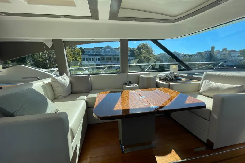 Slide: The Image of Luxurious interior of a 2020 Tiara 53C yacht with elegant seating and wooden table. - 18