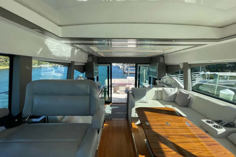 Slide: The Image of Luxurious interior of 2020 Tiara 53C yacht with plush seating and elegant wood table. - 20