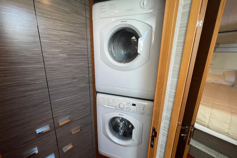 Slide: The Image of Stacked washer and dryer in Tiara 53C yacht, 2020 model, with wood paneling. - 29