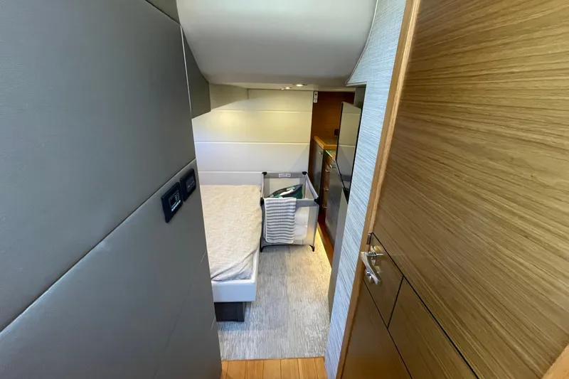 Slide: The Image of Interior of 2020 Tiara 53C yacht, featuring a cozy bedroom with modern design. - 30
