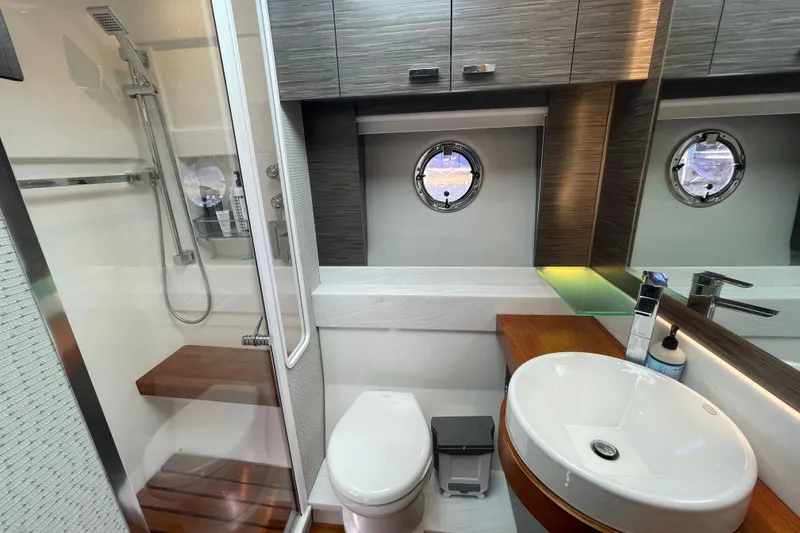 Slide: The Image of Luxurious Tiara 53C 2020 yacht bathroom with modern fixtures and porthole window. - 32