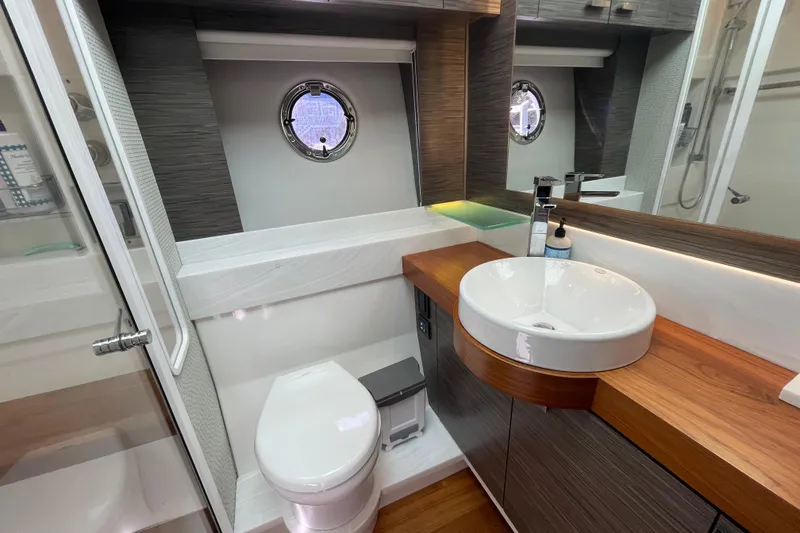 Slide: The Image of Luxurious bathroom in 2020 Tiara 53C yacht with modern fixtures and porthole window. - 33