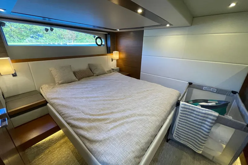 Slide: The Image of Luxurious bedroom interior of 2020 Tiara 53C yacht with modern design and cozy bedding. - 37