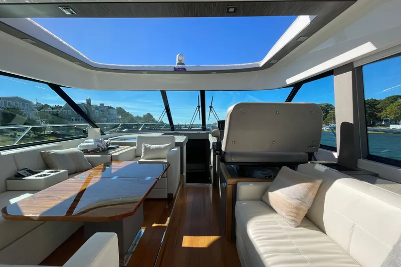 Slide: The Image of Luxurious interior of a 2020 Tiara 53C yacht with elegant seating and panoramic windows. - 40