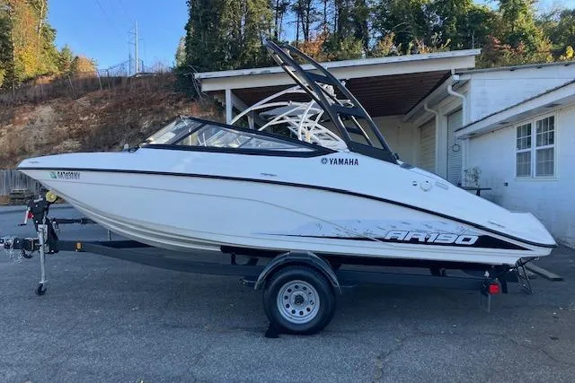 The Image of 2023 Yamaha Boats AR190 on trailer, parked outdoors near a building. - 0