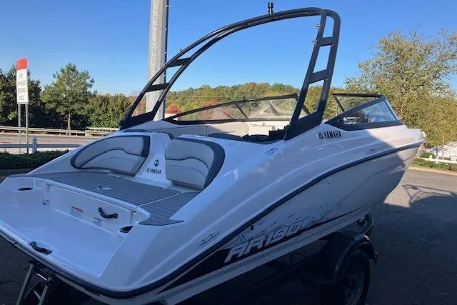 Slide: The Image of 2023 Yamaha AR190 boat with sleek design, parked outdoors on a trailer. - 1