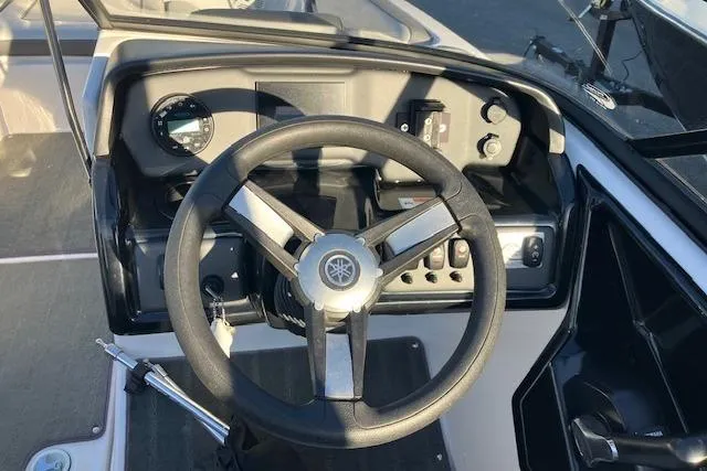 Slide: The Image of 2023 Yamaha Boats AR190 steering wheel and dashboard controls. - 2