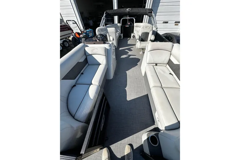 Slide: The Image of 2021 Crest Classic LX 220 SLC pontoon boat interior with spacious seating and modern design. - 10
