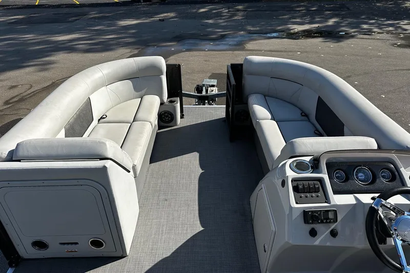 Slide: The Image of 2021 Crest Classic LX 220 SLC pontoon boat interior with plush seating and modern dashboard. - 3