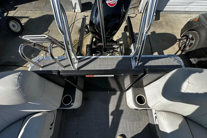 Slide: The Image of 2021 Crest Classic LX 220 SLC boat interior with seating and motor view. - 5