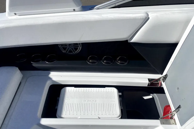 Slide: The Image of 2026 Four Winns H6 boat interior with storage compartment and Igloo cooler. - 11
