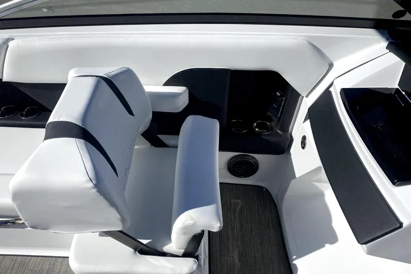 Slide: The Image of Interior of 2026 Four Winns H6 boat featuring sleek white seating and cup holders. - 12