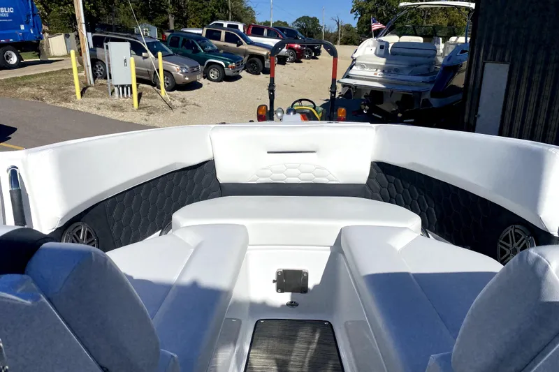 Slide: The Image of 2026 Four Winns H6 boat interior with white seating and hexagonal pattern accents. - 17