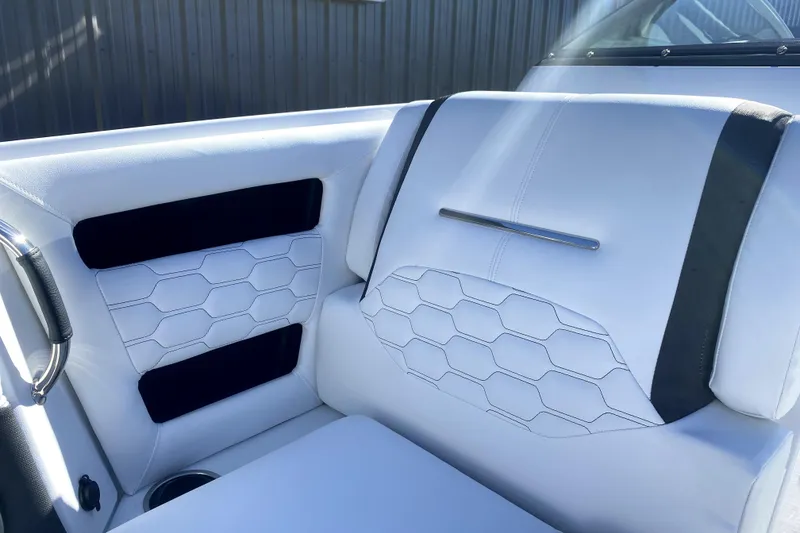 Slide: The Image of Luxurious white seating in 2026 Four Winns H6 boat, featuring modern hexagonal stitching. - 18