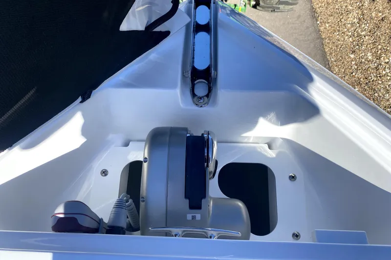 Slide: The Image of 2026 Four Winns H6 boat anchor compartment with winch and rope storage. - 20