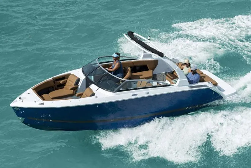 Slide: The Image of Manufacturer Provided Image: 2025 Four Winns H6 boat cruising on turquoise water, featuring sleek design and spacious seating. - 21