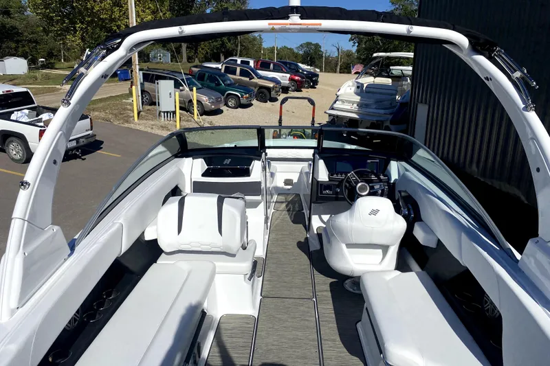Slide: The Image of 2026 Four Winns H6 boat interior with sleek white seating and modern dashboard. - 8