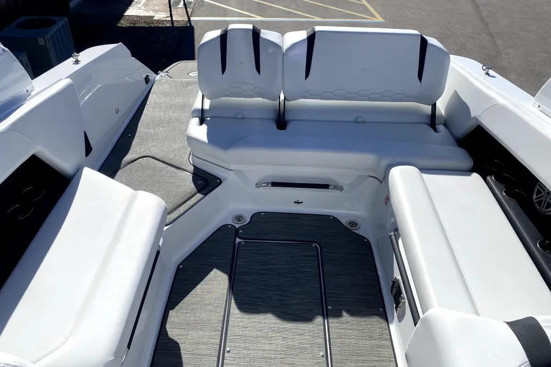 Slide: The Image of Interior of 2026 Four Winns H6 boat with white seating and modern design. - 9