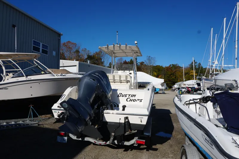 Slide: The Image of 2019 Cobia 237 Center Console boat with Yamaha engine in a marina. - 10