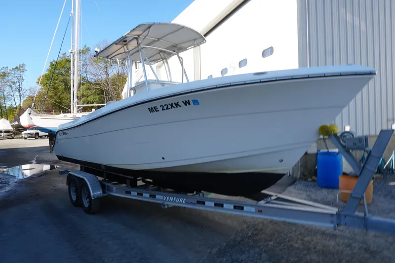 Slide: The Image of 2019 Cobia 237 Center Console boat on trailer near marina building. - 13