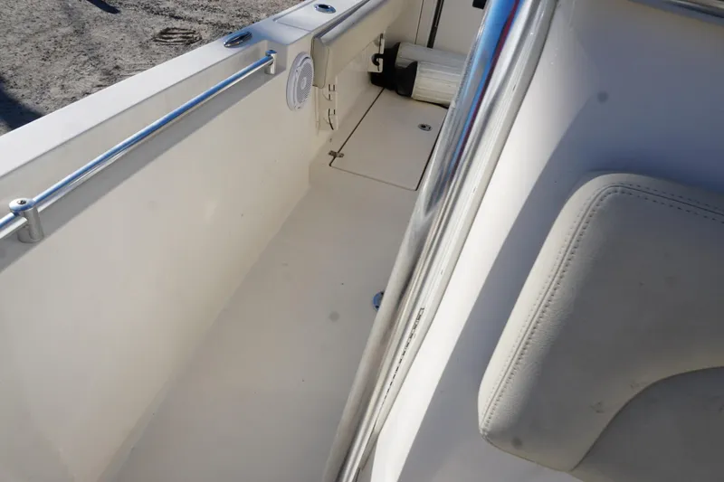 Slide: The Image of 2019 Cobia 237 Center Console boat interior with seating and railing. - 17