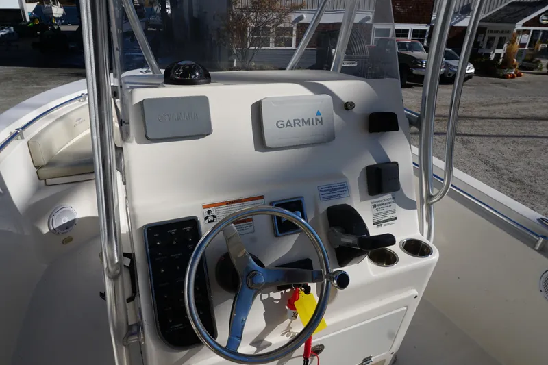 Slide: The Image of 2019 Cobia 237 Center Console boat dashboard with Garmin and Yamaha controls. - 18