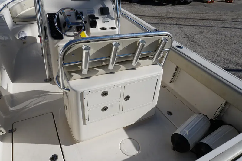 Slide: The Image of 2019 Cobia 237 Center Console boat interior with steering wheel and storage compartments. - 19