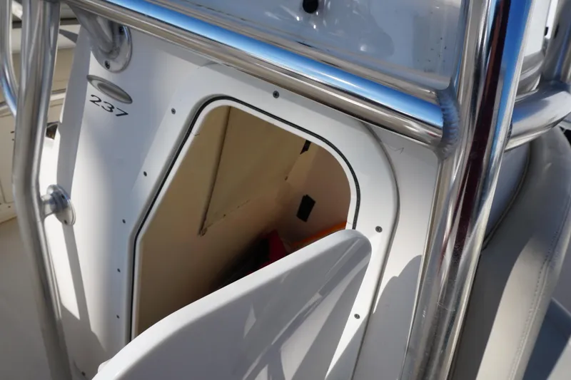 Slide: The Image of 2019 Cobia 237 Center Console boat storage compartment with open door. - 20