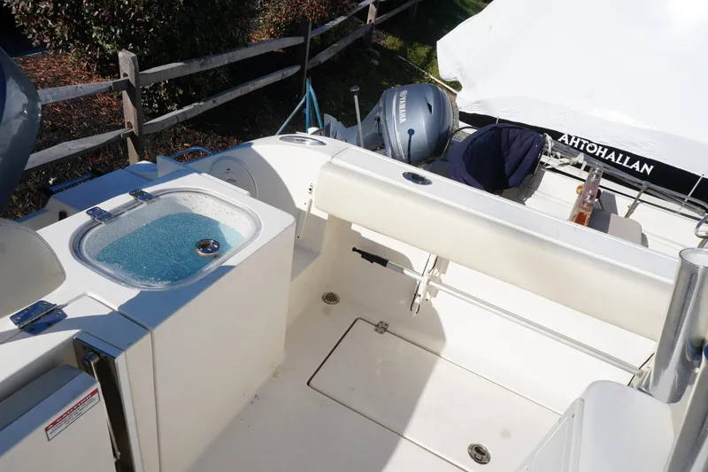 Slide: The Image of 2019 Cobia 237 Center Console boat interior with Yamaha engine and livewell. - 23