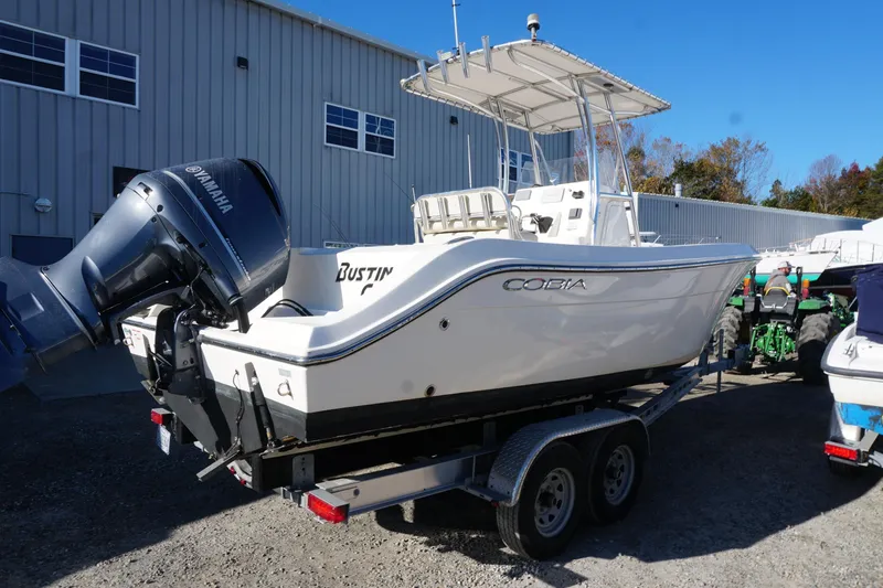 Slide: The Image of 2019 Cobia 237 Center Console boat on trailer with Yamaha engine, parked outdoors. - 5