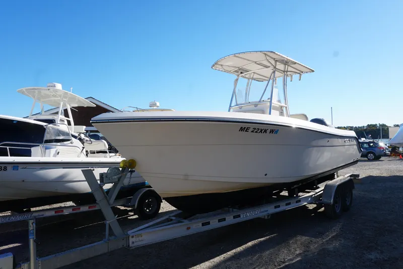 Slide: The Image of 2019 Cobia 237 Center Console boat on trailer under clear blue sky. - 8