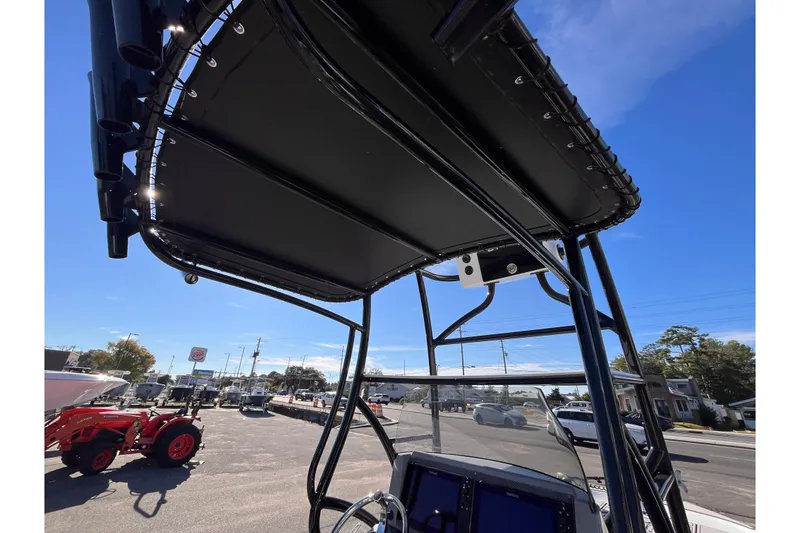 Slide: The Image of 2020 Turner Boatworks 2410 VS T-top and console, outdoor display, clear sky background. - 11