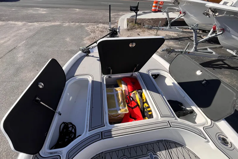 Slide: The Image of Open storage compartments on a 2020 Turner Boatworks 2410 VS, showcasing safety gear and equipment. - 15