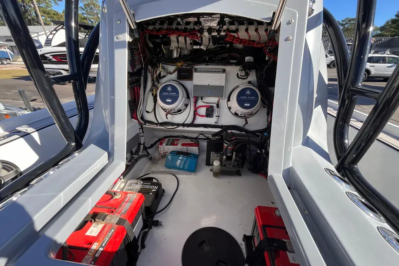 Slide: The Image of Interior view of a 2020 Turner Boatworks 2410 VS showing electrical components and wiring. - 17