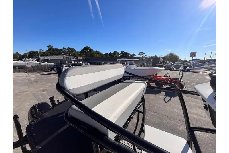Slide: The Image of 2020 Turner Boatworks 2410 VS with seating, displayed outdoors under clear blue sky. - 21
